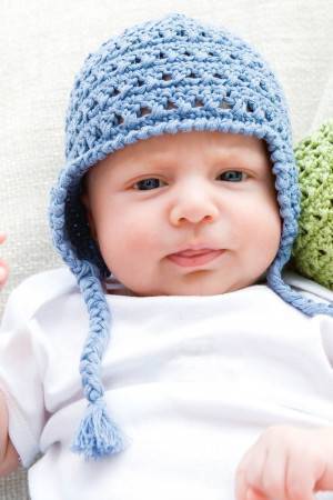 Crocheted baby hat with plaited tassels