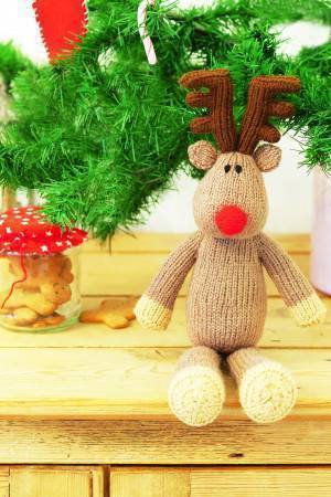 Knitted Christmas reindeer toy with red nose