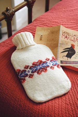Knitted cover for hot water bottle with ribbed neck and Fair Isle motif