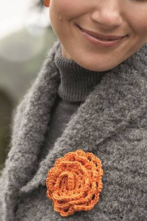 Crochet floral brooch with bright orange to enhance any knit