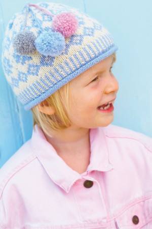 Patterned knitted winter hat for a girl with three pom-poms
