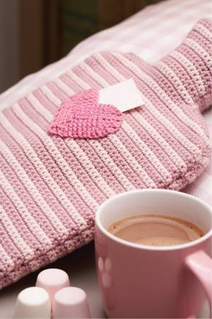 Pretty hot water bottle crochet cover with tiny heart motif