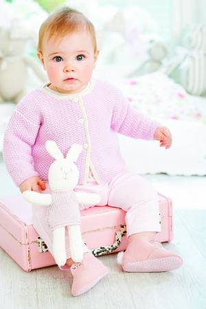 Baby girl wearing pale pink moss stitch knitted cardigan