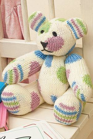 Knitted pastel-patterned teddy bear toy