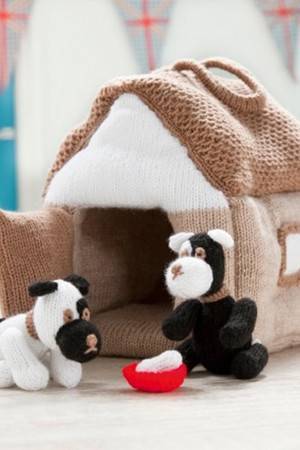 Two knitted two-tone puppies with their own kennel and food bowl