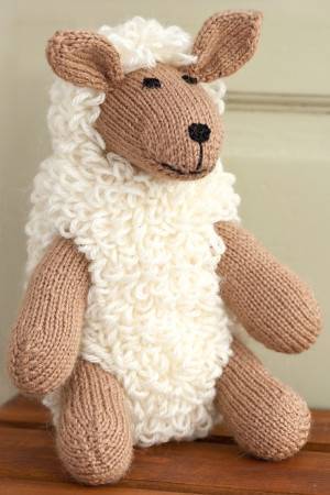 Loopy knitted sheep toy with perky ears and happy face
