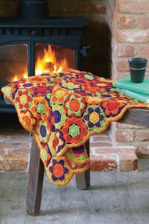 Crocheted hexagon blanket in bright orange, green, yellow and purple