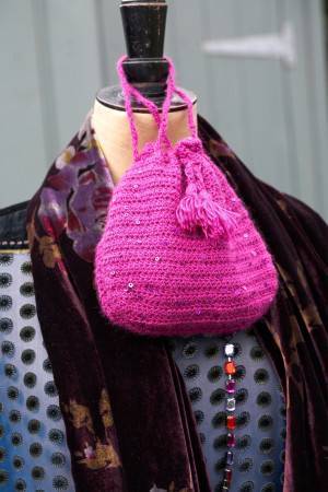 Crochet pouch evening bag with drawstring neck and decorative tassel