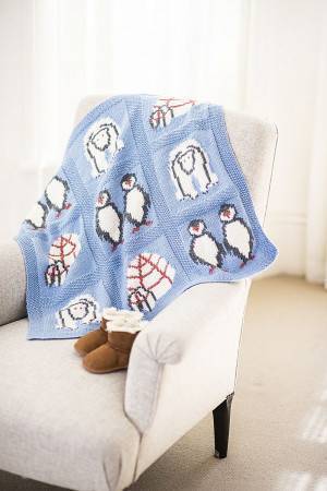 blue knitted baby blanket with intarsia penguins and igloos