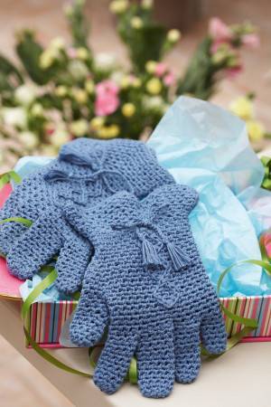 Retro crocheted pair of blue gloves with tassels around wrist