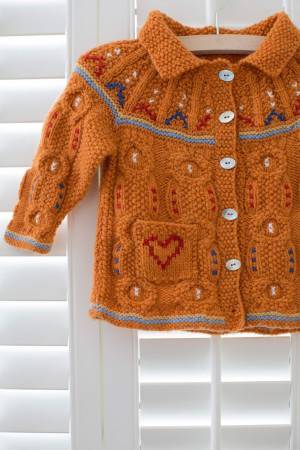 Knitted baby's cardigan with embroidery