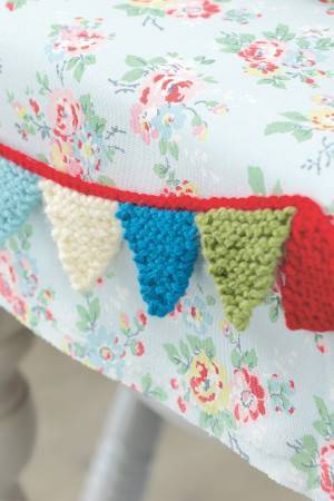 Knitted mini baby bunting with pretty little pennants
