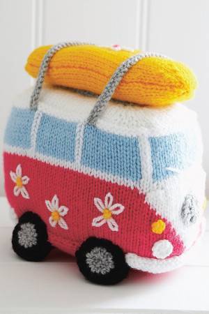Knitted jolly camper van toy with surfboard strapped on roof