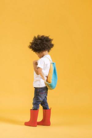 child with knitted drawstring rucksack