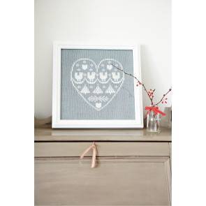 Framed knitted sampler within a heart in white and silver yarn