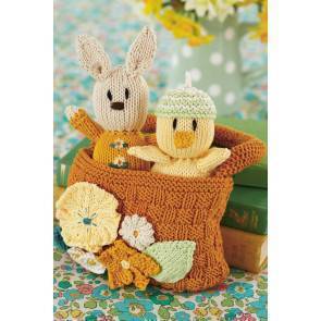 Knitted toy chick and rabbit in basket with floral motif