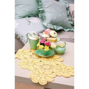 Crocheted table mat with six joined flower patterns in lemon yellow