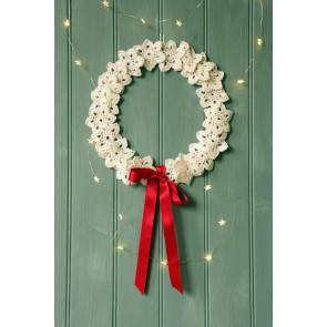 Christmas wreath made from crochet snowflakes and red ribbon